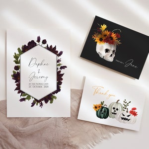 May include: Three printable cards with a Halloween theme. The first card features a skull with a floral crown, the second card has a floral wreath with a hexagonal frame and the text "Daphne & Jeremy, At The Floral Cafe, 23. October 2020", and the third card has three jack-o'-lantern pumpkins with a thank you message.
