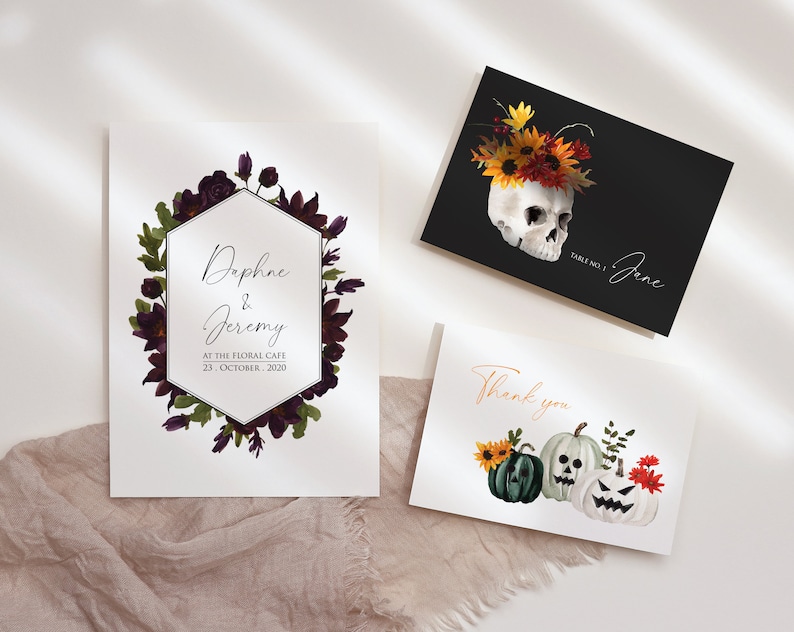 May include: Three printable cards with a Halloween theme. The first card features a skull with a floral crown, the second card has a floral wreath with a hexagonal frame and the text "Daphne & Jeremy, At The Floral Cafe, 23. October 2020", and the third card has three jack-o'-lantern pumpkins with a thank you message.