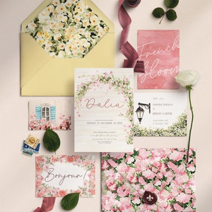 May include: Wedding invitation suite with a floral theme. The invitation features a watercolor illustration of pink flowers and greenery, with the text "Dalia" in a pink script font. The RSVP card features a watercolor illustration of a street lamp and greenery, with the text "Daphne Wilson & Jeremy Carter" in a black script font. The envelope features a watercolor illustration of pink flowers and greenery.