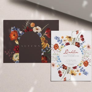 May include: Two floral design cards. One is a dark brown rectangle with an arch of colorful flowers and the word "AUTUMN". The other is a white square with a floral border and the word "Dahlia".