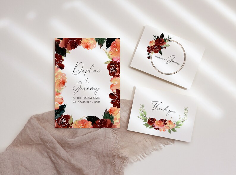 May include: Three cards with watercolor floral wreaths. The top card says "Daphne & Jeremy" with the date "23. October. 2020" and the text "At The Floral Cafe". The middle card says "Table No. 1 Jane". The bottom card says "Thank you".