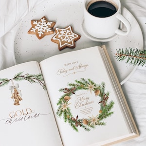 May include: An open book with Christmas illustrations featuring gold bells and a wreath, accompanied by two star-shaped cookies with white icing and a white mug of black coffee on a speckled plate, with a green pine branch nearby.