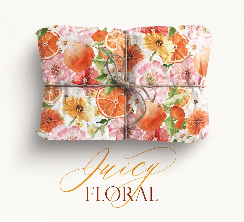 May include: A gift box wrapped in white paper with a floral and citrus pattern. The paper features watercolor illustrations of oranges, lemons, and pink and yellow flowers. The box is tied with twine.