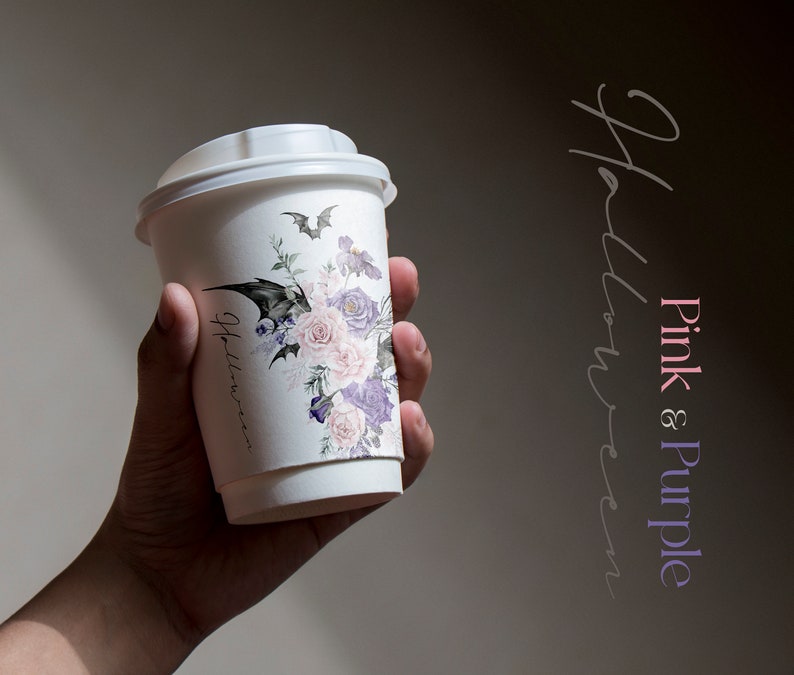 May include: A white paper coffee cup with a pink and purple floral design and a bat graphic. The text "Halloween" is written on the cup.