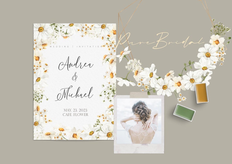 May include: A wedding invitation with a white floral border and the text "Wedding Invitation" "Andrea & Michael" "May 23, 2023" "Cafe Flower".