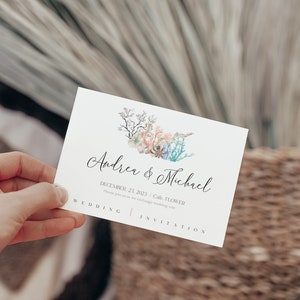May include: Wedding invitation card with a watercolor illustration of coral and seaweed. The card reads "Andrew & Michael" and "December 23, 2023 | Cafe, FLOWER".