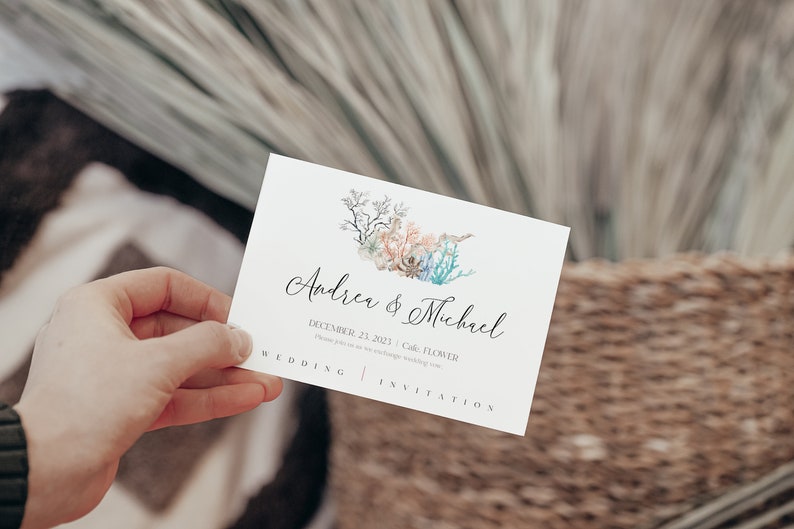 May include: Wedding invitation card with a watercolor illustration of coral and seaweed. The card reads "Andrew & Michael" and "December 23, 2023 | Cafe, FLOWER".