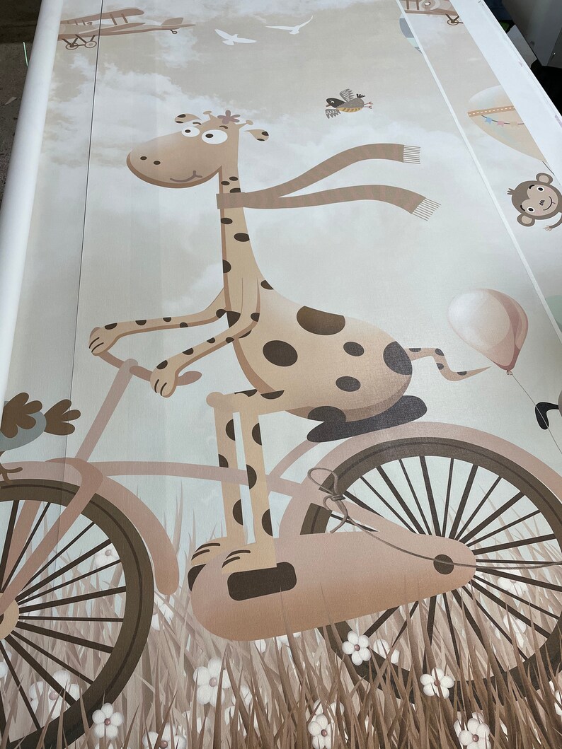 May include: A brown and white giraffe riding a bicycle with a brown balloon in the background. The giraffe is wearing a brown scarf and has brown spots. The bicycle has brown wheels and a brown frame.