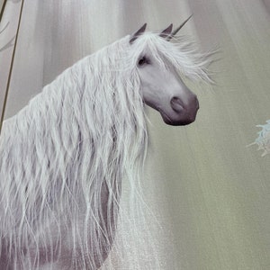 May include: A white unicorn with a long flowing mane and tail stands against a light gray and green background. The unicorn's horn is visible and its head is turned to the side.
