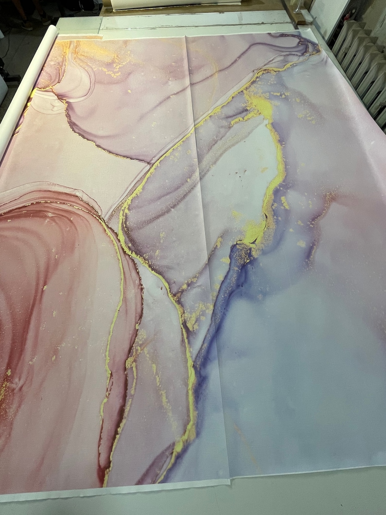 May include: A pink and purple abstract background with gold accents. The background has a marbled look with swirls and lines.