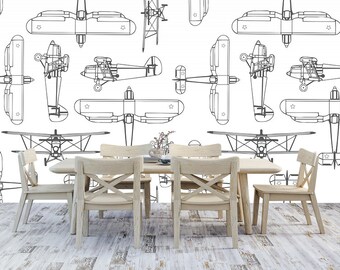 May include: A white background with a repeating pattern of black and white outline drawings of aeroplanes. The image shows a dining room table with four chairs. The table is made of wood and has a light brown finish. The chairs are also made of wood and have a light brown finish.