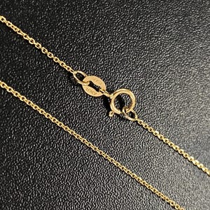 May include: A gold chain necklace with a clasp that says "925 ITALY".