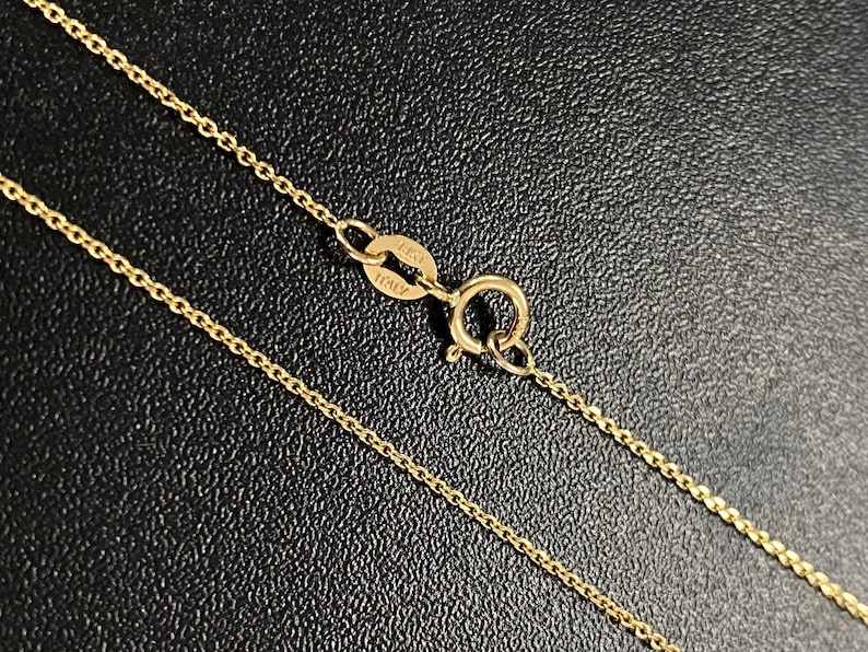 May include: A gold chain necklace with a clasp that says "925 ITALY".