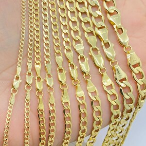 May include: A set of gold chains of varying widths and lengths. The chains are arranged in a fan shape, with the widest chain at the top and the narrowest chain at the bottom. The chains are all made of 10k gold.