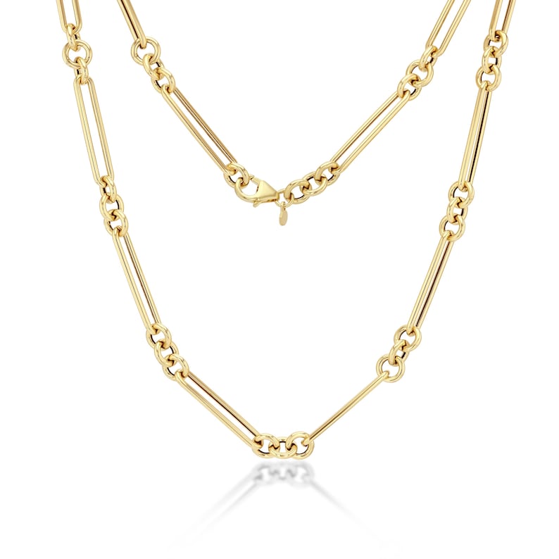 May include: A gold-colored necklace with a paperclip chain design. The necklace features elongated rectangular links connected by smaller, textured links. The clasp is visible at the top, and the necklace is displayed against a white background.