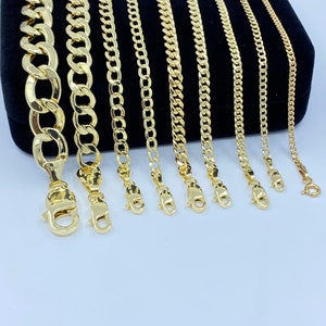 May include: A set of eight gold chains of varying widths and lengths, displayed on a black velvet background. The chains are all made of a classic curb link style.