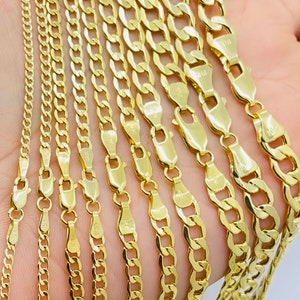 May include: A set of ten gold chains of varying widths and lengths. The chains are arranged in a fan shape, with the widest chain at the top and the narrowest chain at the bottom.