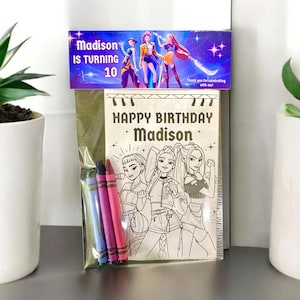 May include: A birthday coloring book set with a purple and blue banner that reads "Madison is turning 10." The coloring book has a black and white illustration of three girls and the words "Happy Birthday Madison."