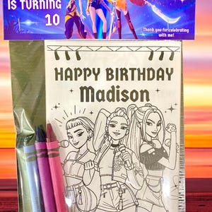 May include: A birthday-themed coloring book set with crayons. The cover reads "HAPPY BIRTHDAY Madison" and features illustrations of three animated characters. The top banner says "Madison IS TURNING 10". Includes blue, purple, and pink crayons.