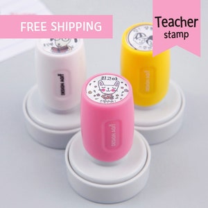 May include: Three teacher stamps with different designs. The first stamp features a cartoon dog wearing a graduation cap. The second stamp features a cartoon bunny with the Korean text "귀고야" and "도장사세요". The third stamp features a cartoon boy and girl wearing graduation caps.