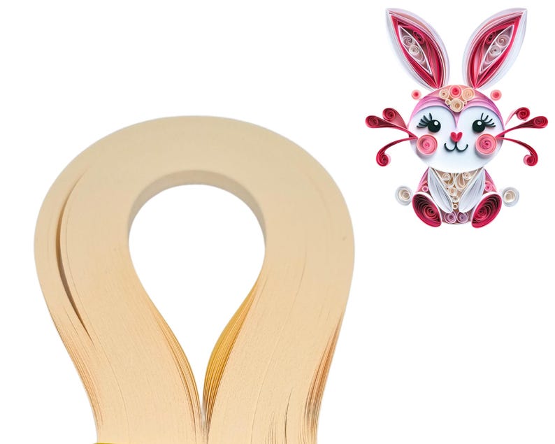 May include: A roll of cream-colored paper quilling strips. The strips are thin and delicate, perfect for creating intricate paper crafts.