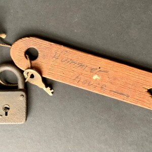 May include: A vintage padlock with a key attached to a wooden tag that reads "Summer House".