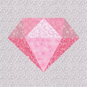 May include: A diamond-shaped quilt block in shades of pink. The block features various floral and leaf patterns, with a light grey background. The design is geometric and symmetrical, showcasing a layered effect with different fabric textures.