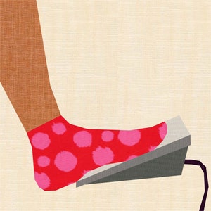 May include: A foot wearing a red sock with pink polka dots steps on a gray foot pedal.