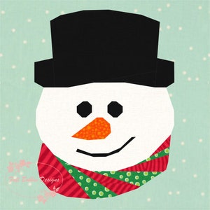 May include: A whimsical snowman face with a black top hat, black eyes, and an orange carrot nose. The snowman wears a red and green striped scarf. The background is a light blue with white dots, creating a wintery scene.