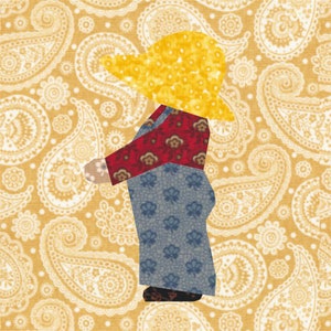May include: A patchwork figure of a person wearing a yellow hat, a red shirt with floral patterns, and blue overalls with floral patterns. The figure is set against a yellow paisley background.