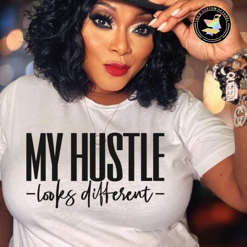 May include: A white t-shirt with black text that reads "MY HUSTLE -looks different- "