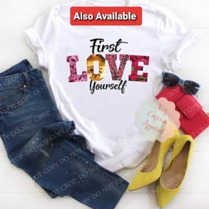 May include: White t-shirt with the text "First Love Yourself" in black and pink letters. The word "Love" is decorated with floral and animal print designs.