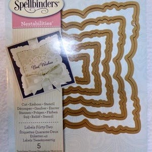 May include: A set of five gold-colored metal die-cut frames with a scalloped edge. The frames are nested inside each other and are labeled "Nestabilities" and "Labels Forty-Two".