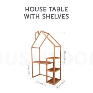 May include: A wooden house-shaped table with shelves. The table is 66.9 inches tall, 43.3 inches wide, and 19.7 inches deep.  HOUSE TABLE WITH SHELVES