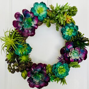 Beautiful  Succulent  wreath in  vibrant colors of teal, purple, green & pink. Treated not to fade.  (This wreath is made to order.)