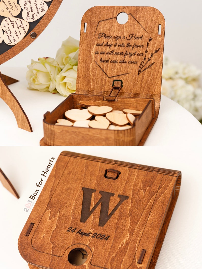 May include: A wooden box with a slot on the top for dropping in small wooden hearts. The box is engraved with the text "Box for Hearts", "24 August 2024", and the letter "W". The lid of the box is open and has the text "Please sign a Heart and drop it into the frame so we will never forget our loved ones who came."