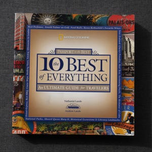 May include: A hardcover travel guide titled "10 Best of Everything" by Nathaniel and Andrew Lande. The cover features a collage of travel-related images and text, including "National Geographic" and "An Ultimate Guide for Travelers."