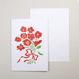 May include: A white card with a red and green floral bouquet illustration. The bouquet is tied with a red ribbon. The card is blank and comes with a white envelope.