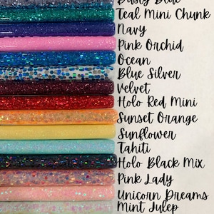 May include: A collection of 16 glitter-filled tubes in various colors, including hot pink, dusty blue, teal, navy, pink orchid, ocean, blue silver, velvet, holo red, sunset orange, sunflower, tahiti, holo black, pink lady, unicorn dreams, mint julep, rollercoaster, and olive.
