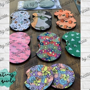 May include: A set of eight colorful, round, fabric coasters with various patterns. The coasters are made of a soft, absorbent material and are perfect for protecting surfaces from spills and scratches.
