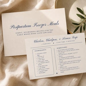 May include: Two off-white recipe cards with dark blue text. The top card reads Postpartum Freezer Meals. The bottom card is titled Chicken, Chickpea, & Lemon Soup and lists ingredients, directions, 6 servings, and a 45-minute cook time.