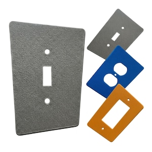 May include: A white ceramic mug with a black handle and the text "But First, Coffee" in a handwritten style. The mug is on a white surface. The mug is approximately 4 inches tall.