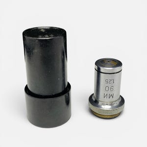 May include: Two black cylindrical microscope parts, one with a silver top and the numbers "90 1.25" printed on it. The other part is a black cylindrical case. The items are on a white background.