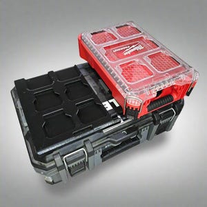May include: A red and black Milwaukee Packout tool box with a clear lid. The lid has a honeycomb pattern and is labeled "Packout".