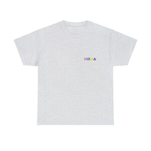 Op de afbeelding: Een grijs t-shirt met het woord "MDMA" geborduurd op de voorkant in kleurrijke letters. De letters zijn roze, geel, blauw en groen.