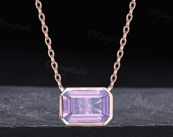 May include: A delicate rose gold chain necklace with a square-shaped pendant featuring a light purple gemstone.