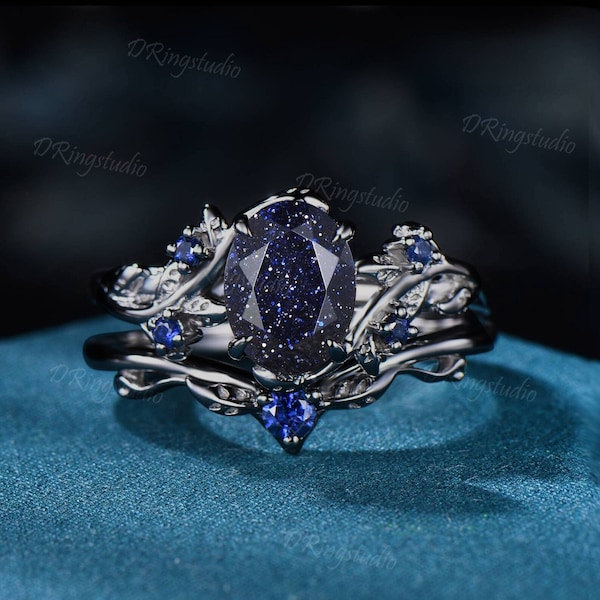 Anillo de compromiso de oro negro de 1,5 quilates con forma ovalada inspirada en la naturaleza, con diseño de galaxia y cielo estrellado, conjunto de anillos de boda de arenisca azul y zafiro azul en racimo.