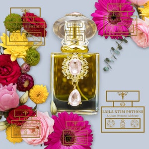 May include: A gold bottle of perfume with a pink crystal stopper and a gold ornate design. The bottle is surrounded by flowers and greenery. The label on the bottle reads "Laila Ntim Potions Artisan Perfume Alchemy".