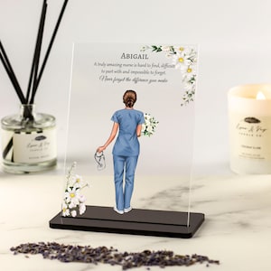 May include: A clear acrylic plaque with a black base featuring a floral design and a nurse illustration. The plaque has the text "ABIGAIL" and the quote "A truly amazing nurse is hard to find, difficult to part with and impossible to forget. Never forget the difference you make."