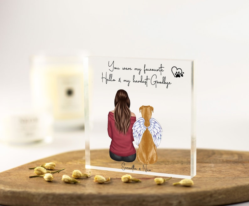 May include: A clear acrylic block with a drawing of a woman and a dog with angel wings. The text reads "You were my favourite Hello & my hardest Goodbye" and "Samantha & Nice".